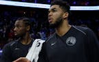 Minnesota Timberwolves' Karl-Anthony Towns, right, and Andrew Wiggins, left, looks on during the second half of an NBA basketball game against the Phi