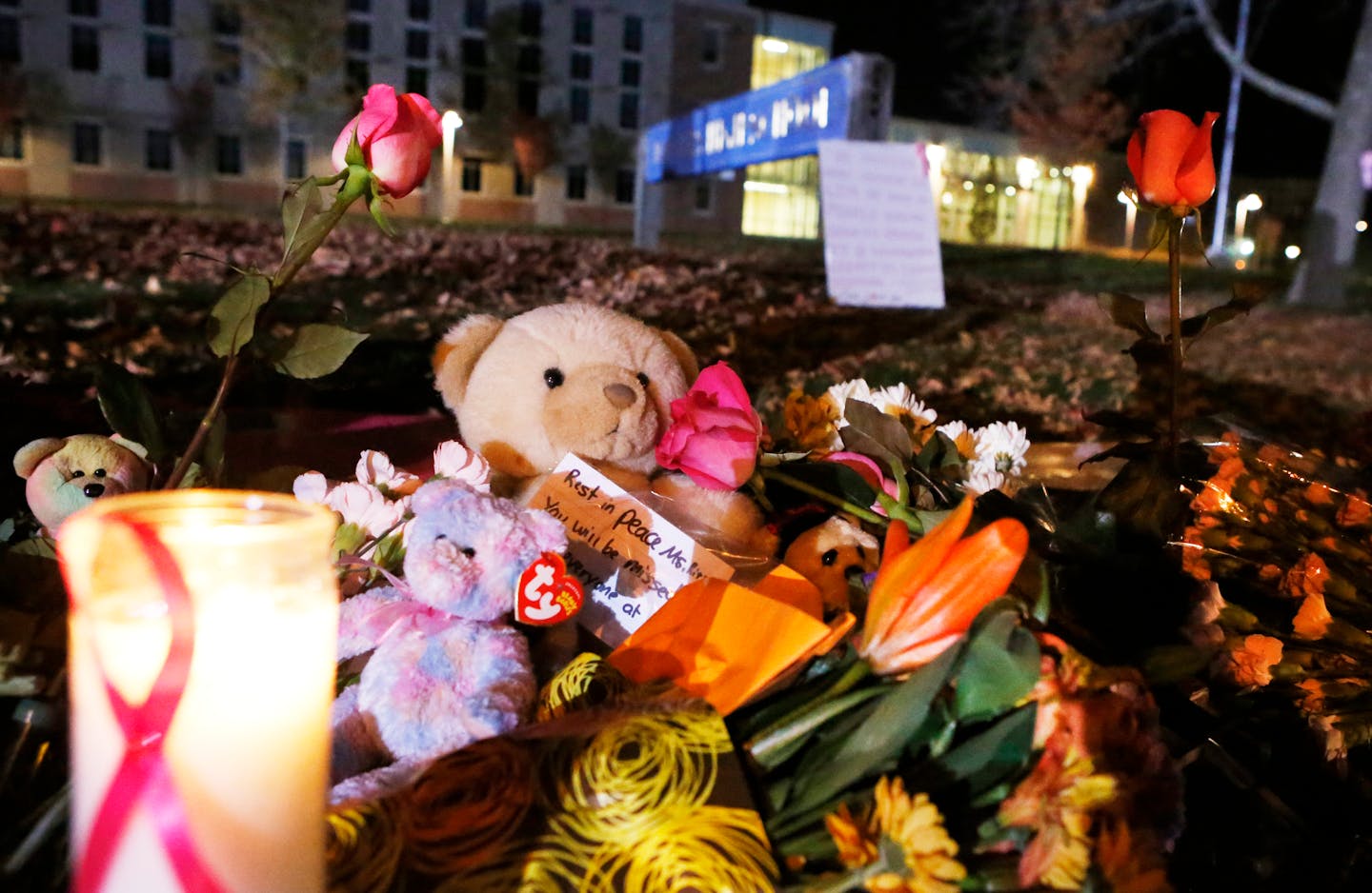 Candles and teddy bears are placed at Danvers High School prior to a candlelight vigil to mourn the death of Colleen Ritzer, a 24-year-old math teacher at Danvers High School on Wednesday, Oct 23, 2013, in Danvers, Mass. Ritzer was found slain in woods behind the high school, and Danvers High School student Philip Chism, 14, who was found walking along a state highway overnight was charged with killing her. (AP Photo/ Bizuayehu Tesfaye)