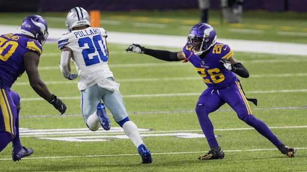 Dallas Cowboys running back Tony Pollard (20) ran past Minnesota Vikings' Jalyn Holmes (90) and Chris Jones (26) on his way to a touchdown in the four