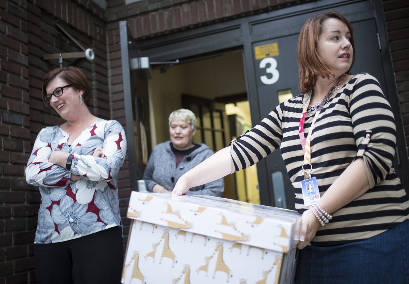 Babies Need Boxes founder and executive director Danielle Selassie, left, and board chairwoman Julie Kemna-Edner, center, waited outside Longfellow High School in Minneapolis as parent educator Melanie Faulhaber prepared to deliver a box of goods.