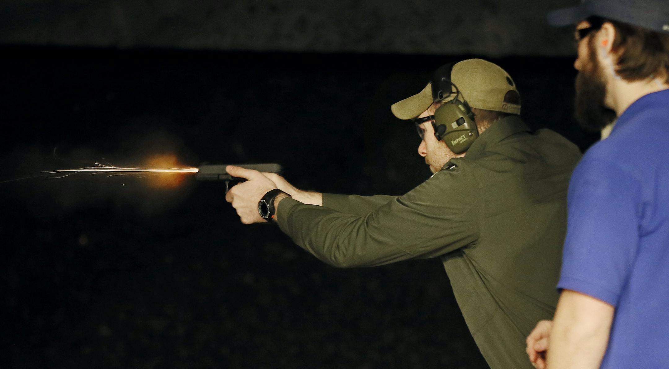 Tyler Edwards fired his pistol with range instructor Peter Johnson at his side at Osseo Gun club Monday March 2, 2015 in Osseo, Minnesota. ] Jerry Holt/ Jerry.Holt@Startribune.com