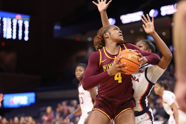 The Gophers’ Rose Micheaux looked to shoot at Virginia on Saturday.