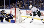 Minnesota Wild's Eric Staal, right, is unable to score past St. Louis Blues goalie Jake Allen and Jay Bouwmeester, left, during the third period in Ga