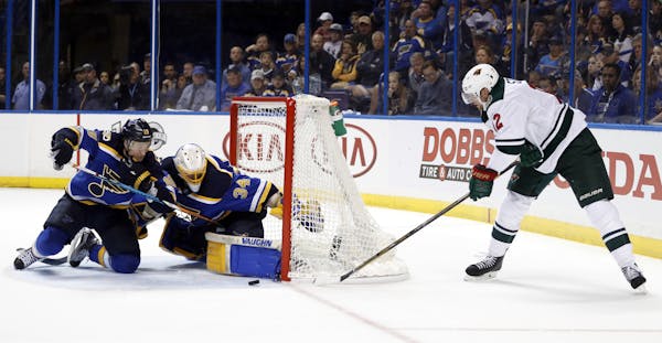 Minnesota Wild's Eric Staal, right, is unable to score past St. Louis Blues goalie Jake Allen and Jay Bouwmeester, left, during the third period in Ga