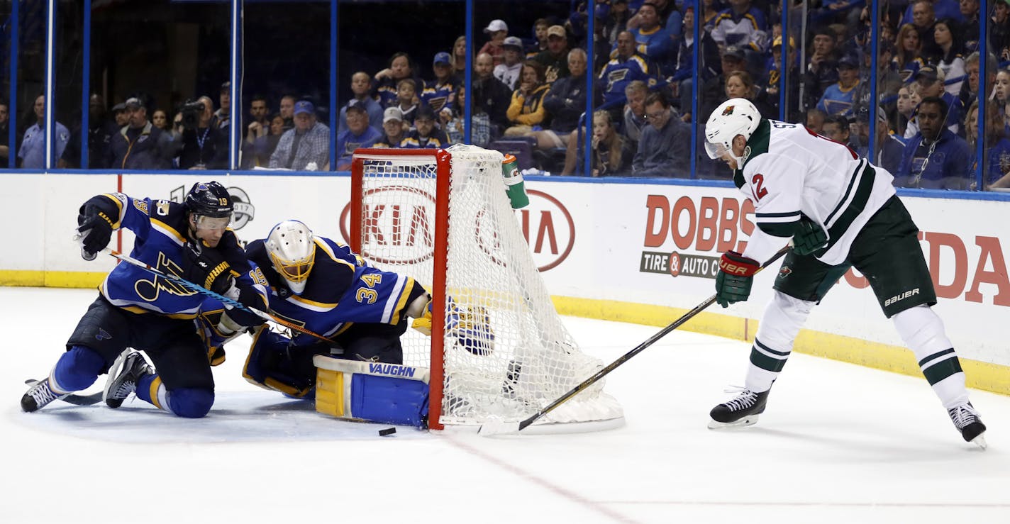 Minnesota Wild's Eric Staal, right, is unable to score past St. Louis Blues goalie Jake Allen and Jay Bouwmeester, left, during the third period in Game 3 of an NHL hockey first-round playoff series Sunday, April 16, 2017, in St. Louis. The Blues won 3-1. (AP Photo/Jeff Roberson)