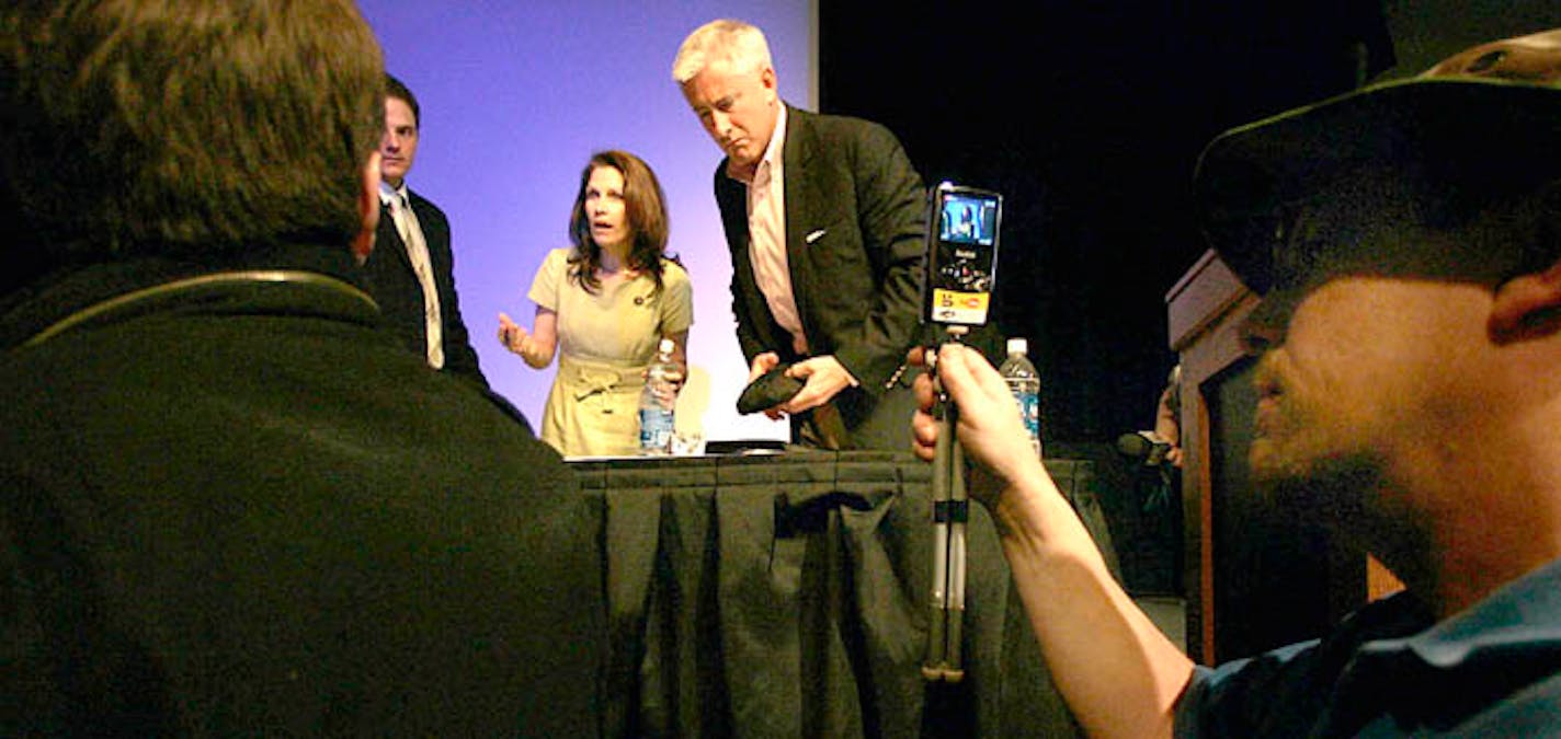 U.S. Rep. Michele Bachmann spoke with a few of those attending a forum at St. Cloud State University on climate change. Chris Horner, right, a senior fellow at the Competitive Enterprise Institute, also spoke.