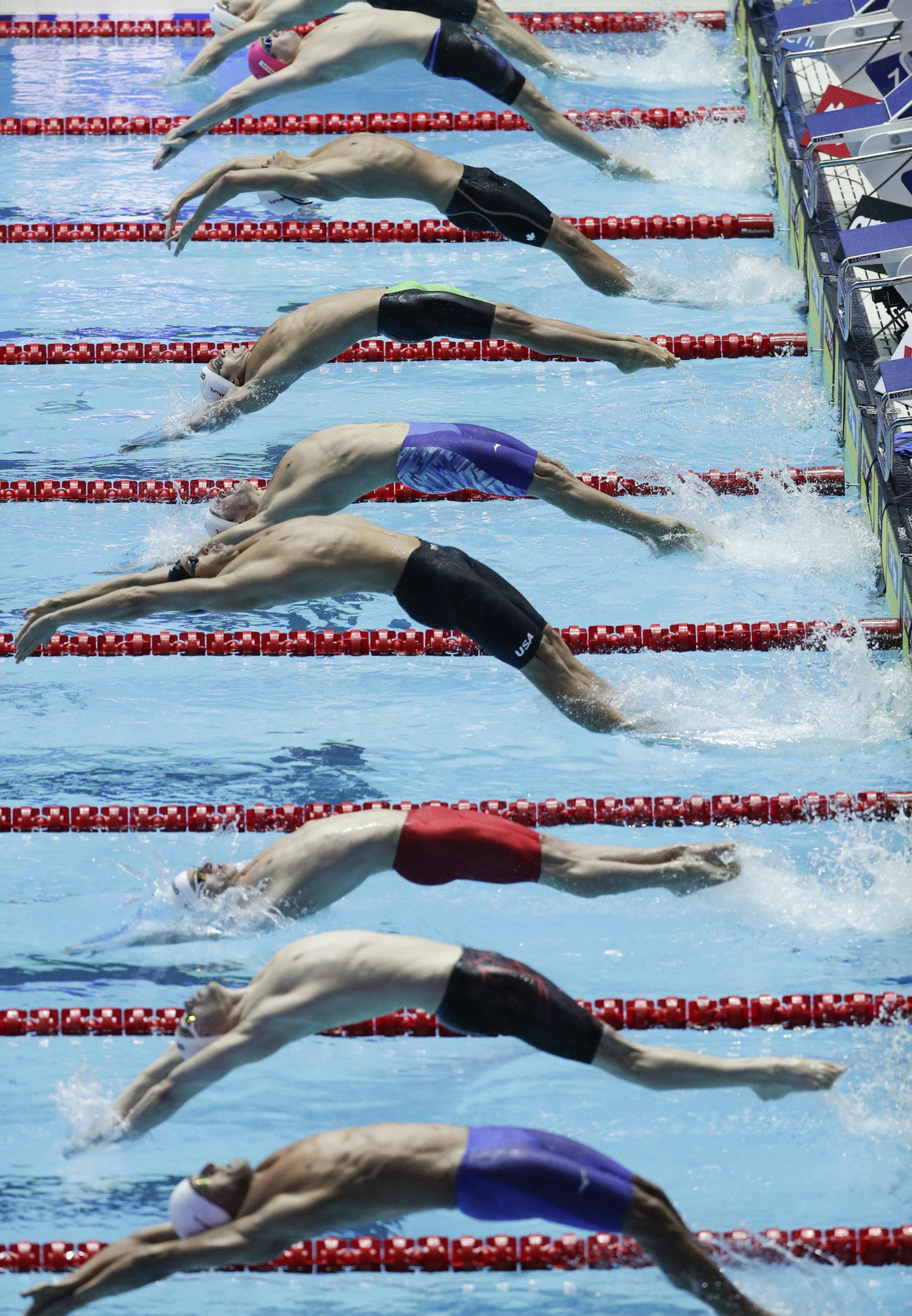 Swimmers start in the men's 100m backstroke semifinal at the World Swimming Championships in Gwangju, South Korea, Monday, July 22, 2019. (AP Photo/Mark Schiefelbein)