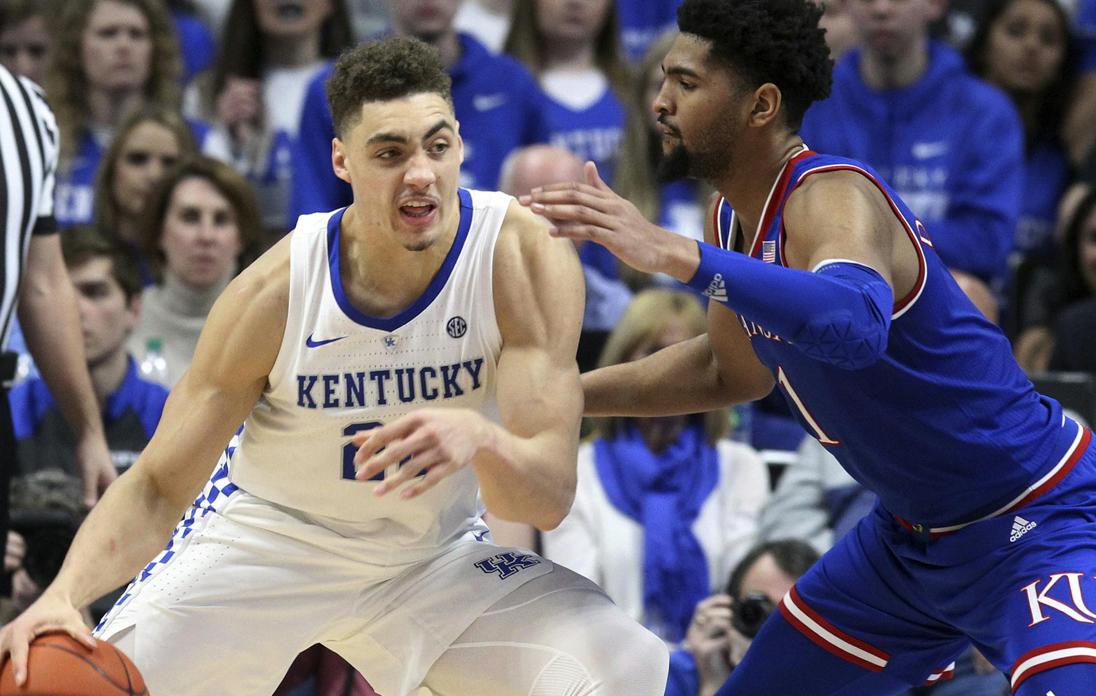 Kentucky's Reid Travis (22) drives on Kansas' Dedric Lawson during the second half of an NCAA college basketball game in Lexington, Ky., Saturday, Jan. 26, 2019. Kentucky won 71-63. (AP Photo/James Crisp) ORG XMIT: KYJC112