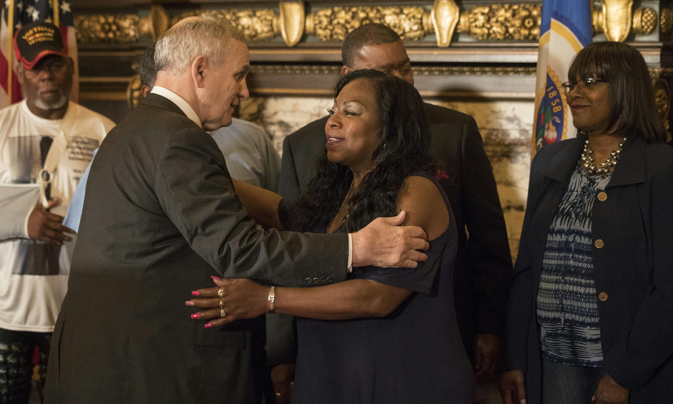 Governor Mark Dayton left embraced Valerie Castile after announcing that a $12 million funding for the "Philando Castile Law Enforcement Training Fund" one year after Castile was killed Thursday July 6, in St. Paul, MN. ] JERRY HOLT &#xef; jerry.holt@startribune.com