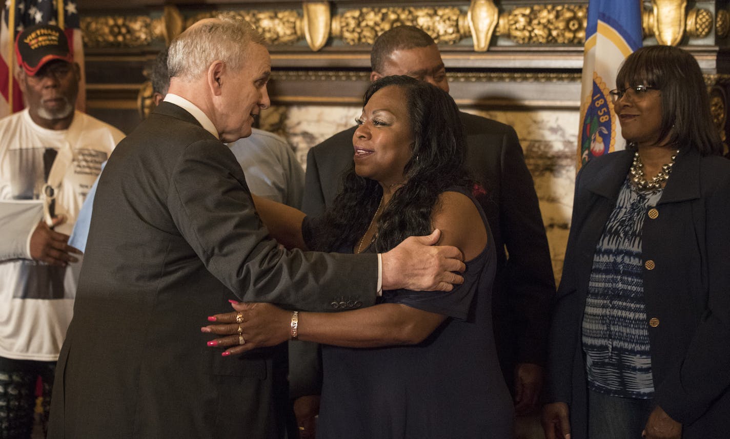 Governor Mark Dayton left embraced Valerie Castile after announcing that a $12 million funding for the "Philando Castile Law Enforcement Training Fund" one year after Castile was killed Thursday July 6, in St. Paul, MN. ] JERRY HOLT &#xef; jerry.holt@startribune.com