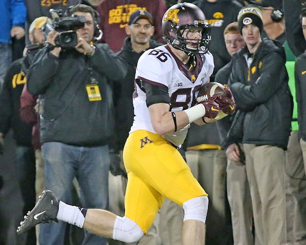 Minnesota's tight end Brandon Lingen carried the ball across the end zone for a touchdown in the second quarter against Iowa.