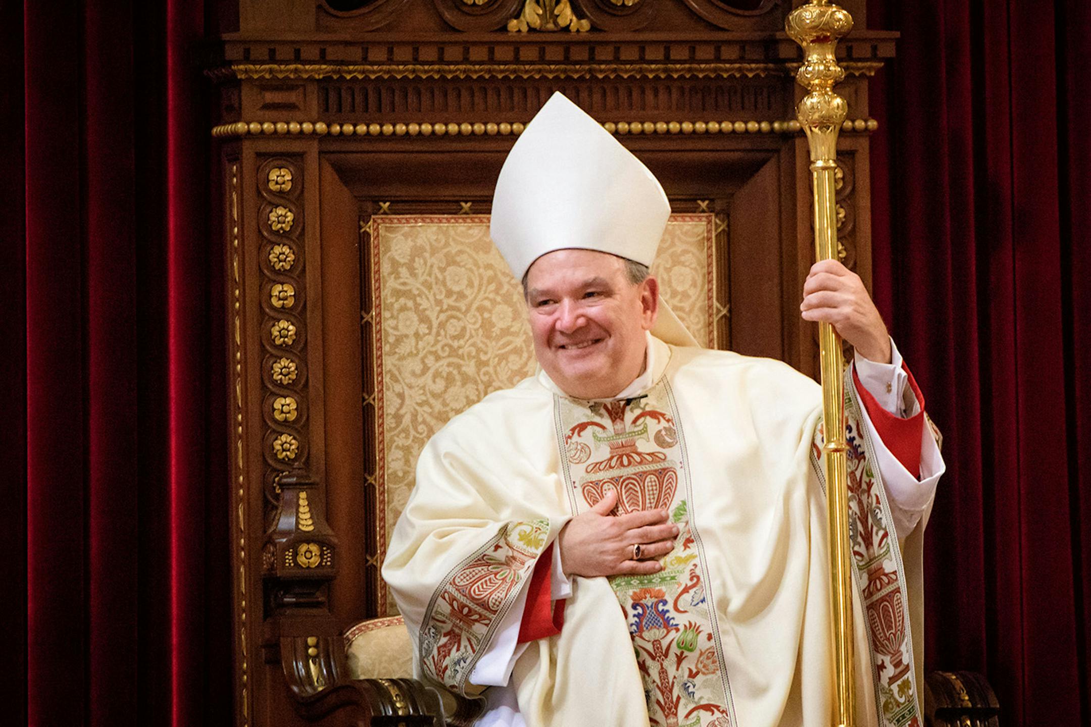 For the first time Archbishop Bernard Hebda took his seat at the cathedra or bishops throne on the altar and acknowledged the sustained applause from the crowd.