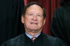 Associate Justice Samuel Alito joins other members of the Supreme Court as they pose for a new group portrait, Oct. 7, 2022, at the Supreme Court buil