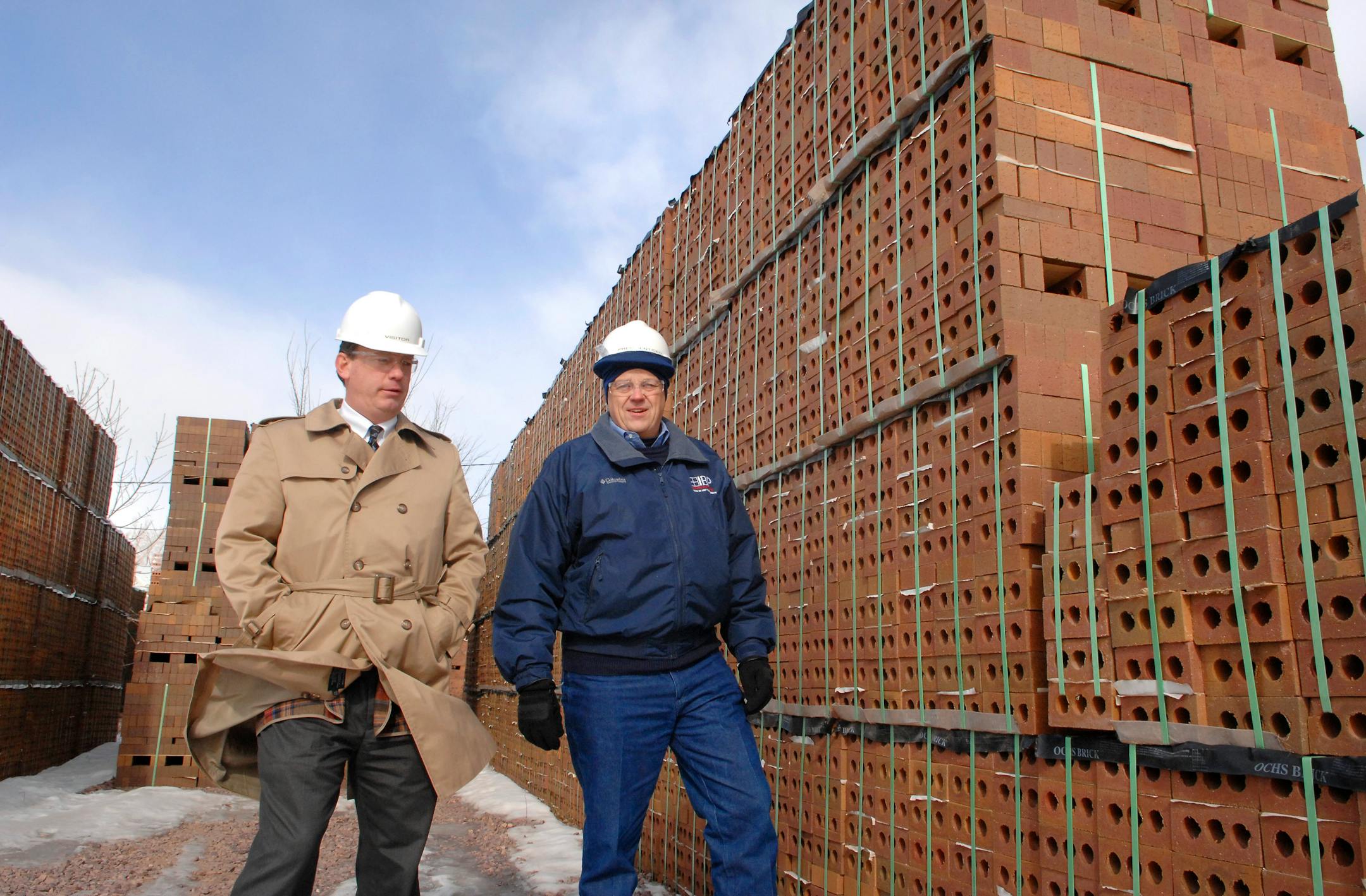 Matt Van Hoomissen, former owner and president of Ochs Brick, now sales manager for Acme-Ochs, left, and Dennis Knautz, Acme's president and chief executive officer, walked through the plant's storage area in Springfield, Minn. Acme bought Ochs after production was suspended due to the soft construction market.