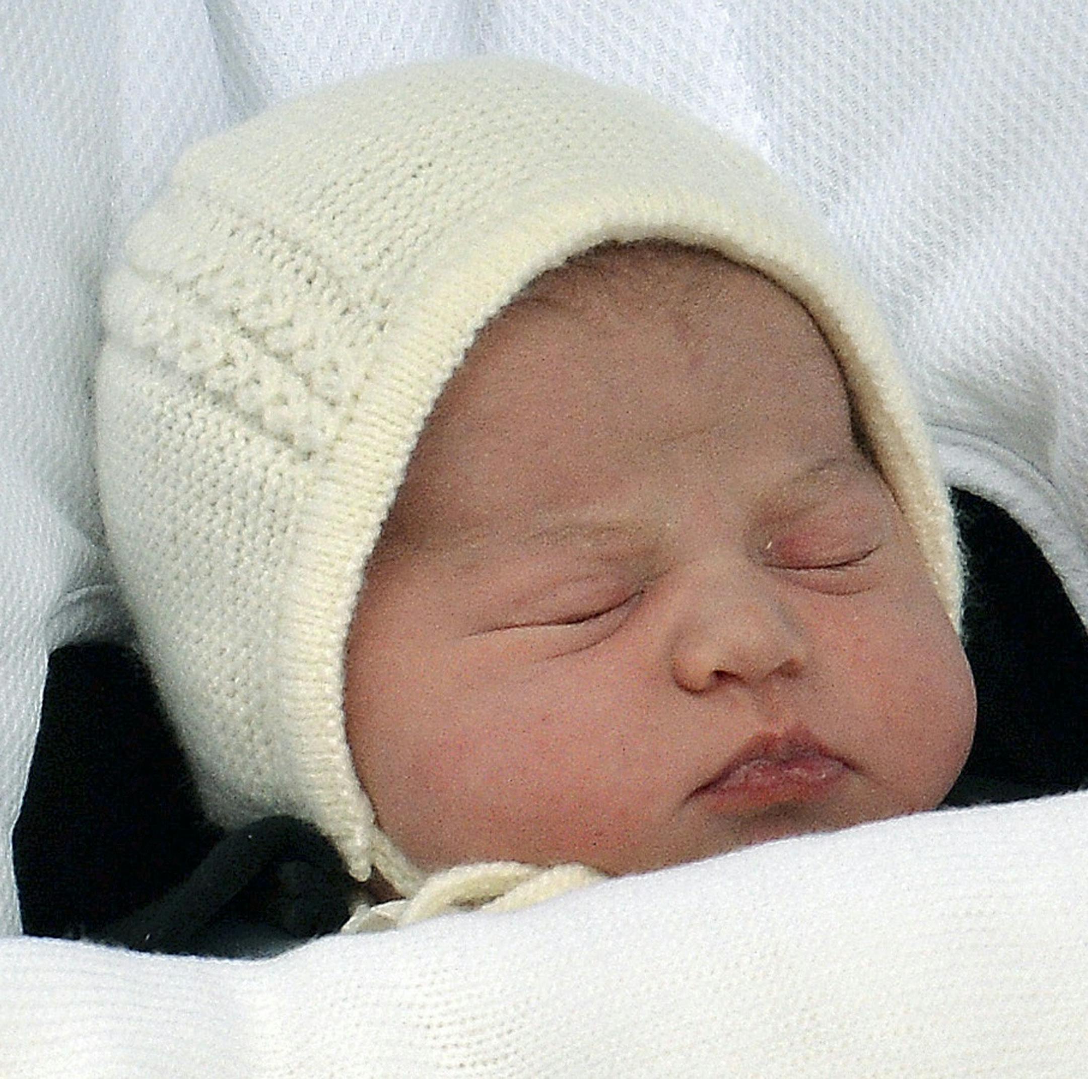 FILE - In this Saturday, May 2, 2015. file photo the newborn baby princess, born to parents Kate Duchess of Cambridge and Prince William, is carried in a car seat by her father from The Lindo Wing of St. Mary's Hospital, in London Britain's newborn princess has been named Charlotte Elizabeth Diana it was announced on Monday May 4. (John Stillwell/Pool via AP, File)