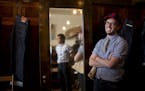 Satchel Moore, right, wore raw denim at BlackBlue in St. Paul, which he manages. Owner Steve Kang was reflected in the mirror.