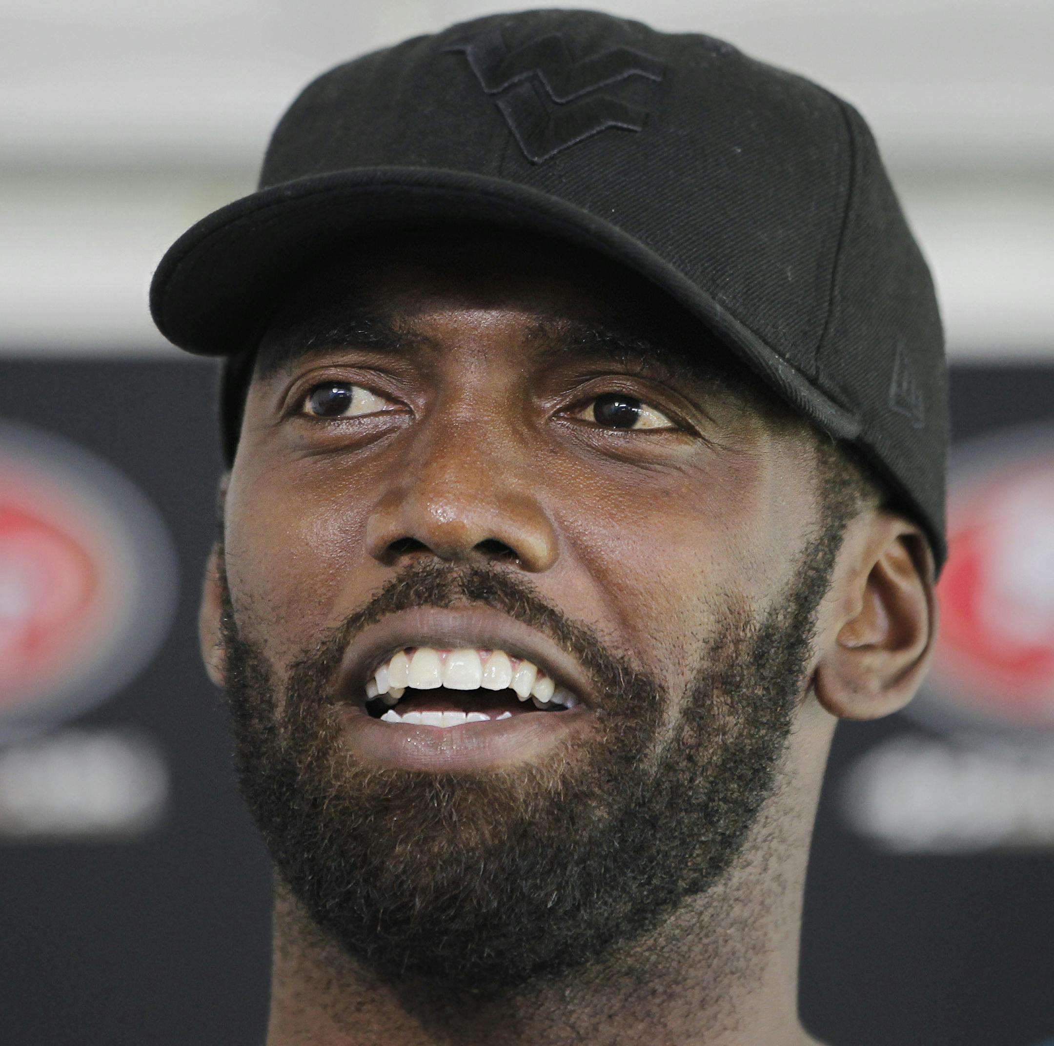 FILE - In this July 27, 2012 file photo, San Francisco 49ers wide receiver Randy Moss smiles during a news conference at the team's NFL football headquarters in Santa Clara, Calif. Both Moss and Seattle Seahawks' Terrell Owens are both determined to return to their dominating deep threats they were in their primes. (AP Photo/Paul Sakuma, file)