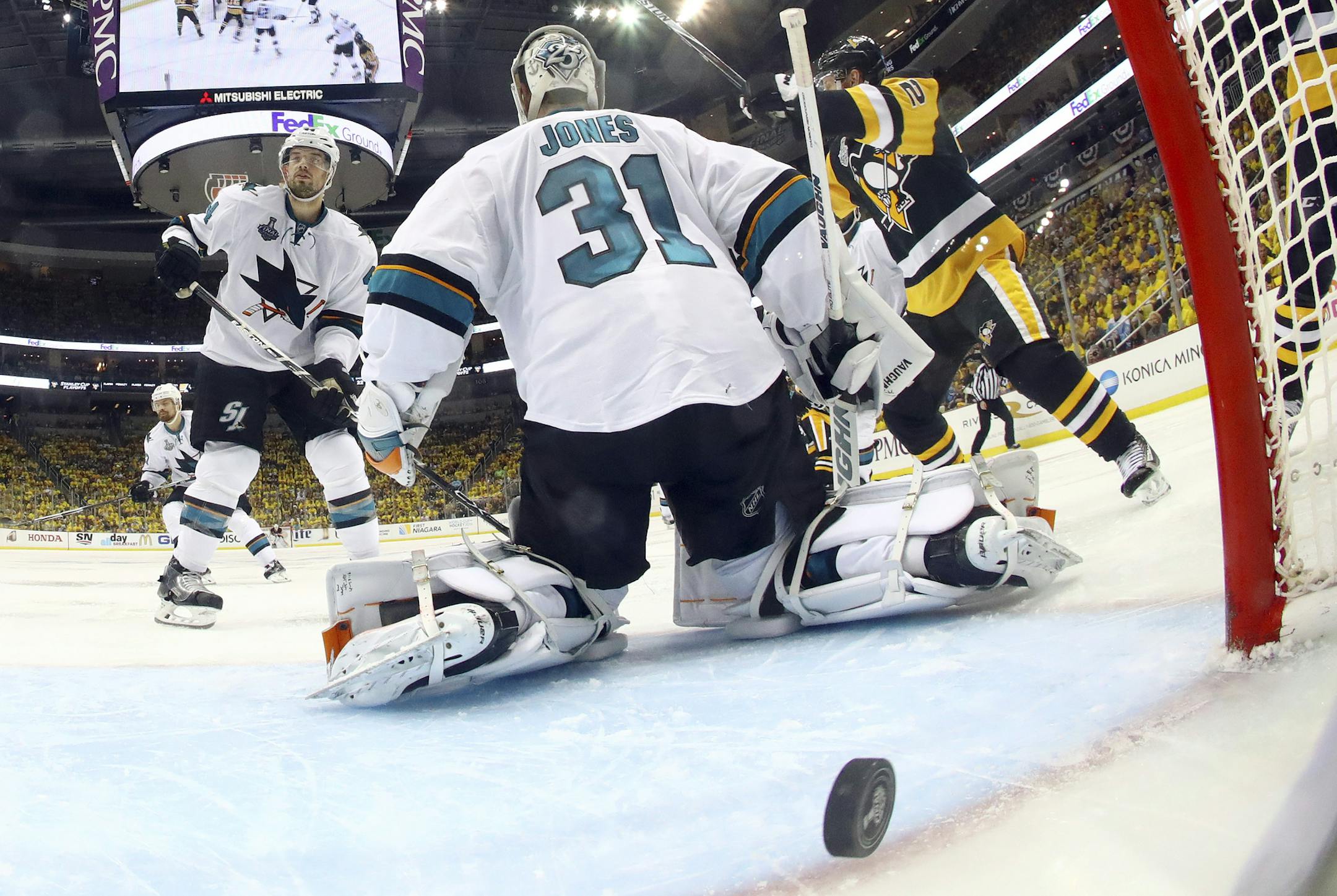 A puck shot by Pittsburgh Penguins' Conor Sheary rattles out of the net on the game-winning goal behind San Jose Sharks goalie Martin Jones during overtime in Game 2 of the NHL hockey Stanley Cup Finals on Wednesday, June 1, 2016, in Pittsburgh. The Penguins won 2-1 to take a 2-0 lead in the series. (Bruce Bennett/Pool Photo via AP)
