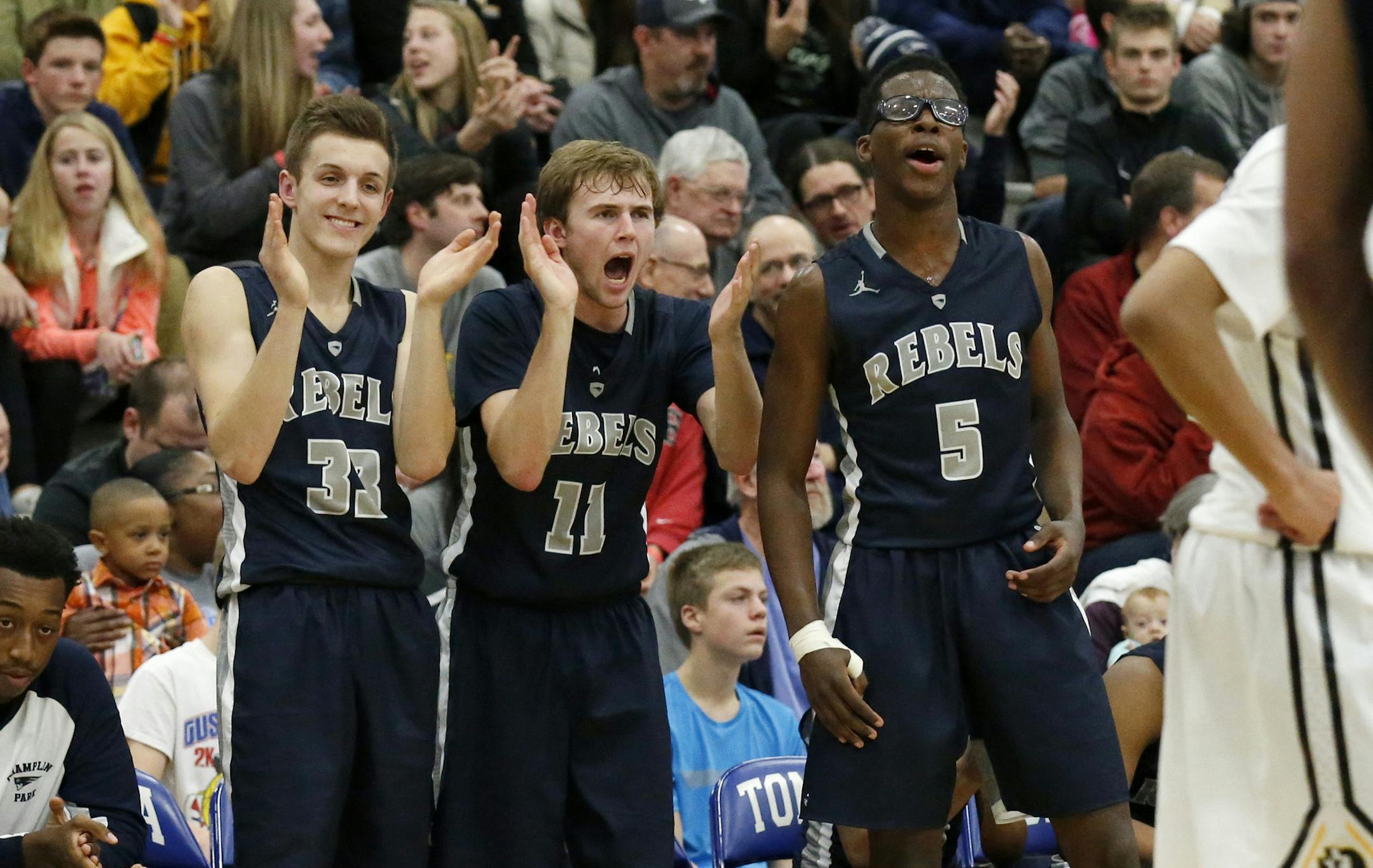 Champlin Park players Jack Martin (33), Aaron Kloeppner (11) and Chris Davis (5) cheer their teammates during the second half against DeLaSalle in Minnetonka, Saturday, Dec. 12, 2015. Champlin Park defeated DeLaSalle 75-68. ( Photo/Ann Heisenfelt) ORG XMIT: 596959 PREP121315 20