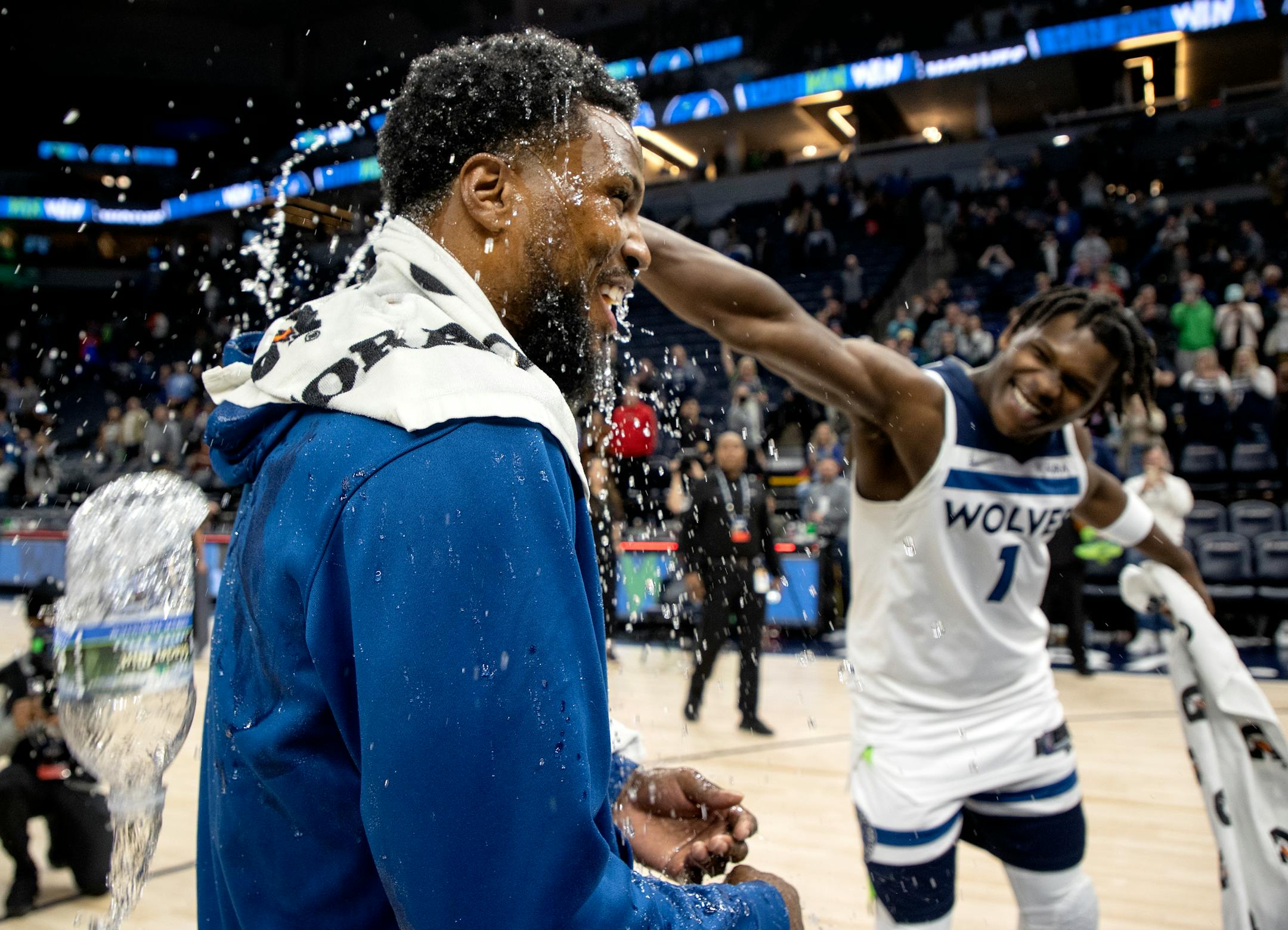 Malik Beasley (5) of the Minnesota Timberwolves is doused with water by teammates including Anthony Edwards (1) at the end of the game.