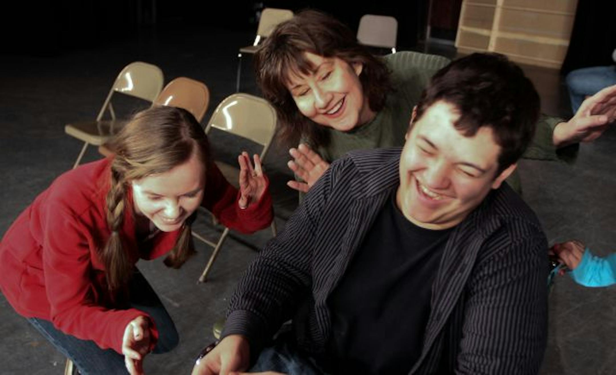(Left) Students Callie McIntosh and (right) Drew Gohman were directed by (center) Irondale High School drama director Janet Paone during a rehearsal of the school's production of "The Man Who Came to Dinner."