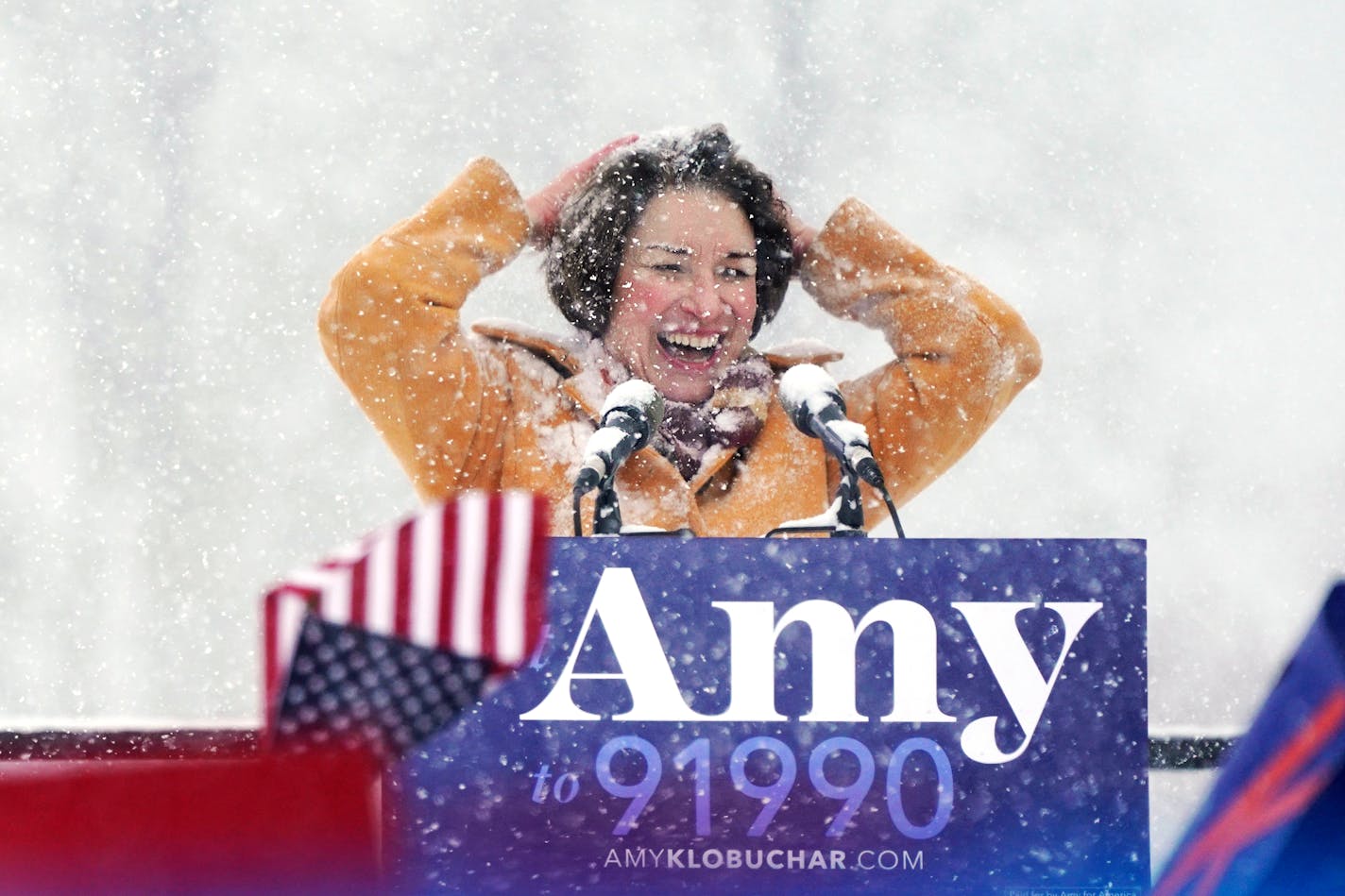 U.S. Sen. Amy Klobuchar wipes snow from her hair after announcing she is running for president of the United States, at Boom Island Park, Sunday, Feb. 10, 2019, in Minneapolis. Klobuchar joined the growing group of Democrats jostling to be president and positioned herself as the most prominent Midwestern candidate in the field, as her party tries to win back voters in a region that helped put Donald Trump in the White House. (Anthony Souffle/Star Tribune via AP)