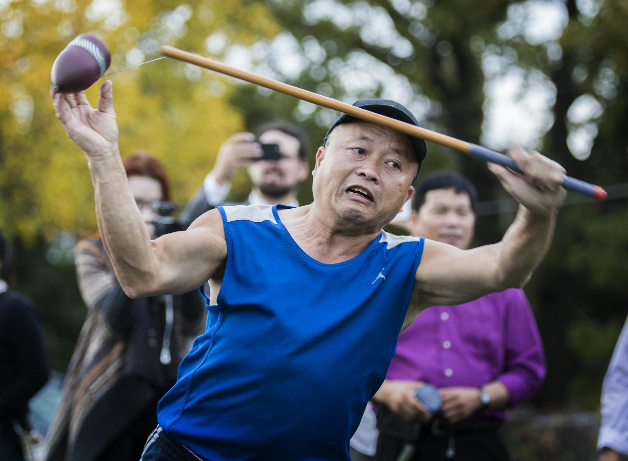 Young Vang demonstrates the game of Tuj Lub.
