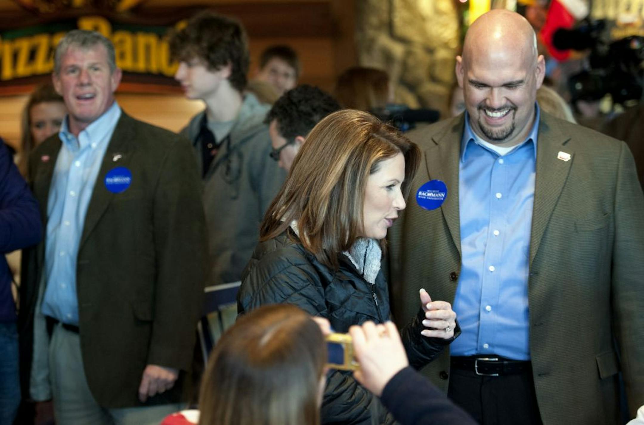 Hours after smiling next to Rep. Michele Bachmann as she greeted supporters at this Indianola, Iowa Pizza Ranch restaurant, Wednesday, December 28, 2011, state Sen. Kent Sorenson, right, gave his endorsement to the Texas congressman Ron Paul at a later Des Moines rally. State Sen. Brad Zaun, left, who had been Bachmann's Iowa co-chairman, was named full chairman after Sorenson's resignation.