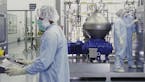 FILE - In this undated image from video provided by Regeneron Pharmaceuticals on Friday, Oct. 2, 2020, scientists work with a bioreactor at a company 