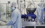 FILE - In this undated image from video provided by Regeneron Pharmaceuticals on Friday, Oct. 2, 2020, scientists work with a bioreactor at a company 