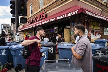 Cup Foods worker Billy Abumayyaleh, right, brother to owner Mahmoud Abumayyaleh, was confronted by an activist on Monday, Aug. 3. He was trying to cle