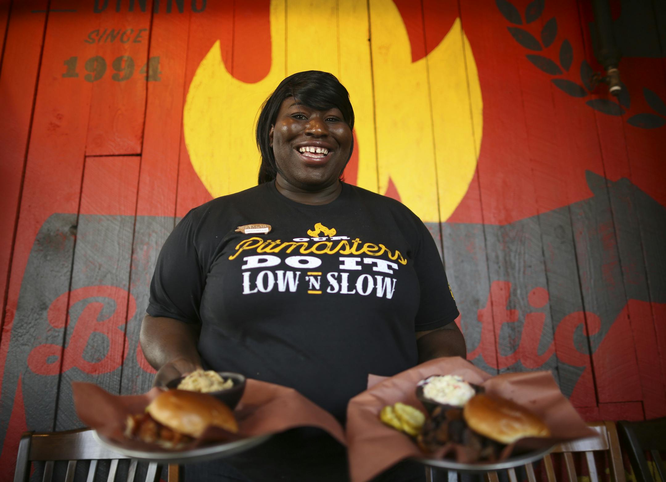 Bartender Michelle Carr in one of the new uniform shirt options for servers with some sandwiches in the boldly refreshed entryway of the Maple Grove Famous Dave's. ] JEFF WHEELER ï jeff.wheeler@startribune.com To counter sales declines, Famous Dave's is refreshing their branding, starting with their Maple Grove location. Founder Dave Anderson and Chief Marketing Officer Alfredo Martel were on hand for the launch event Tuesday evening, September 20, 2016.