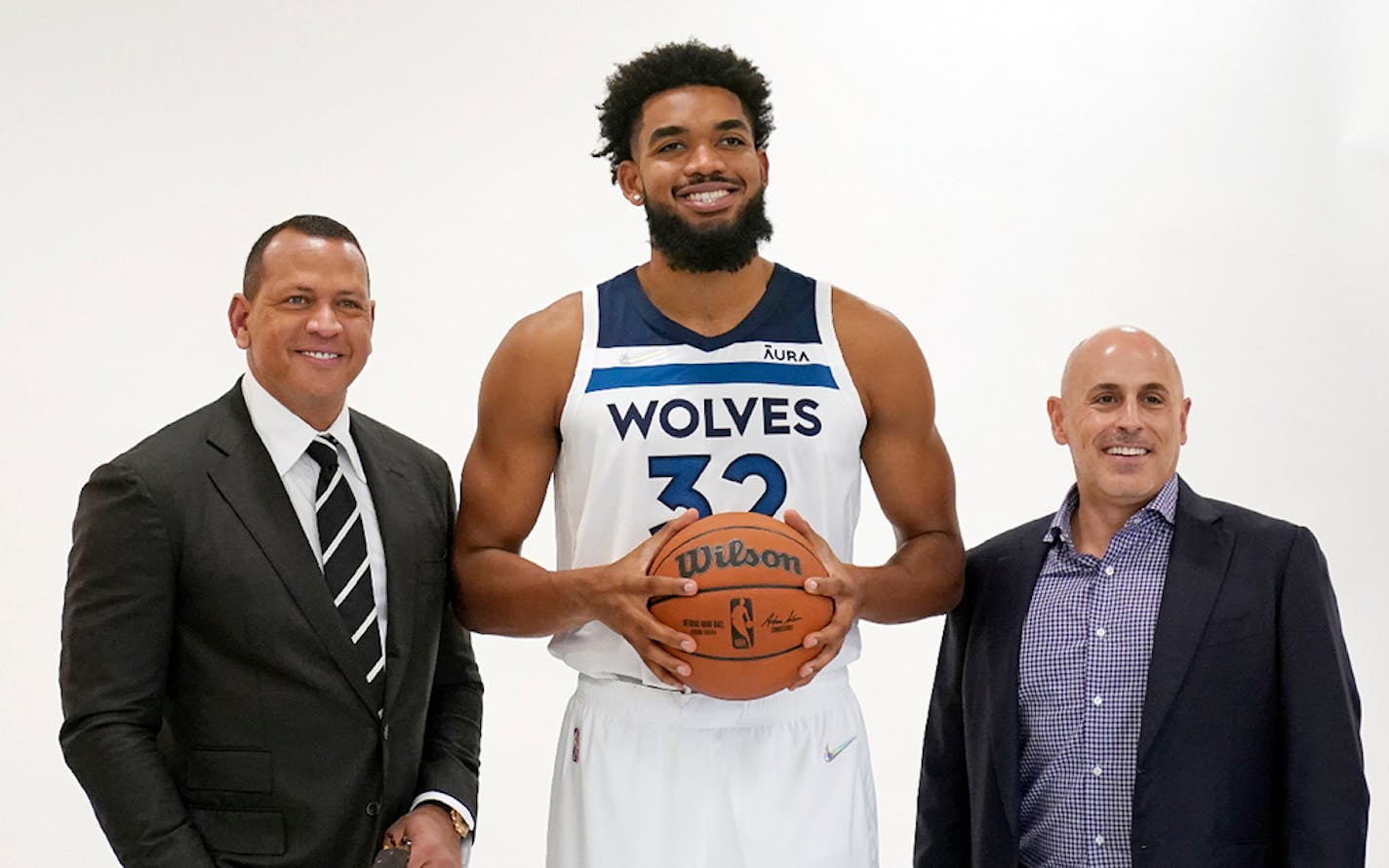 Minnesota Timberwolves' Karl-Anthony Towns, center, poses with new team ownership partners Marc Lore, right, and baseball great Alex Rodriguez, left, during the NBA basketball team's media day, Monday, Sept. 27, 2021, in Minneapolis. (AP Photo/Jim Mone)