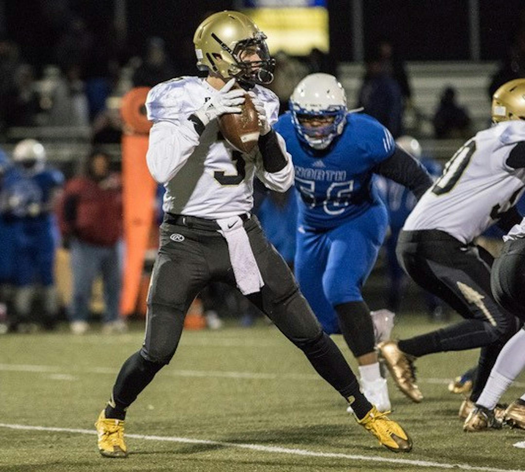 Caledonia quarterback Owen King drops back to pass against Minneapolis North in the Class 2A, State Quarterfinal at Burnsville High School. King threw two touchdown passes in the first half. Photo by Jeff Lawler, SportsEngine