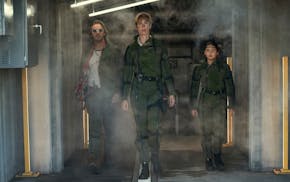 From left, Dan Stevens, Rebecca Hall and Kaylee Hottle in a scene from "Godzilla x Kong: The New Empire."