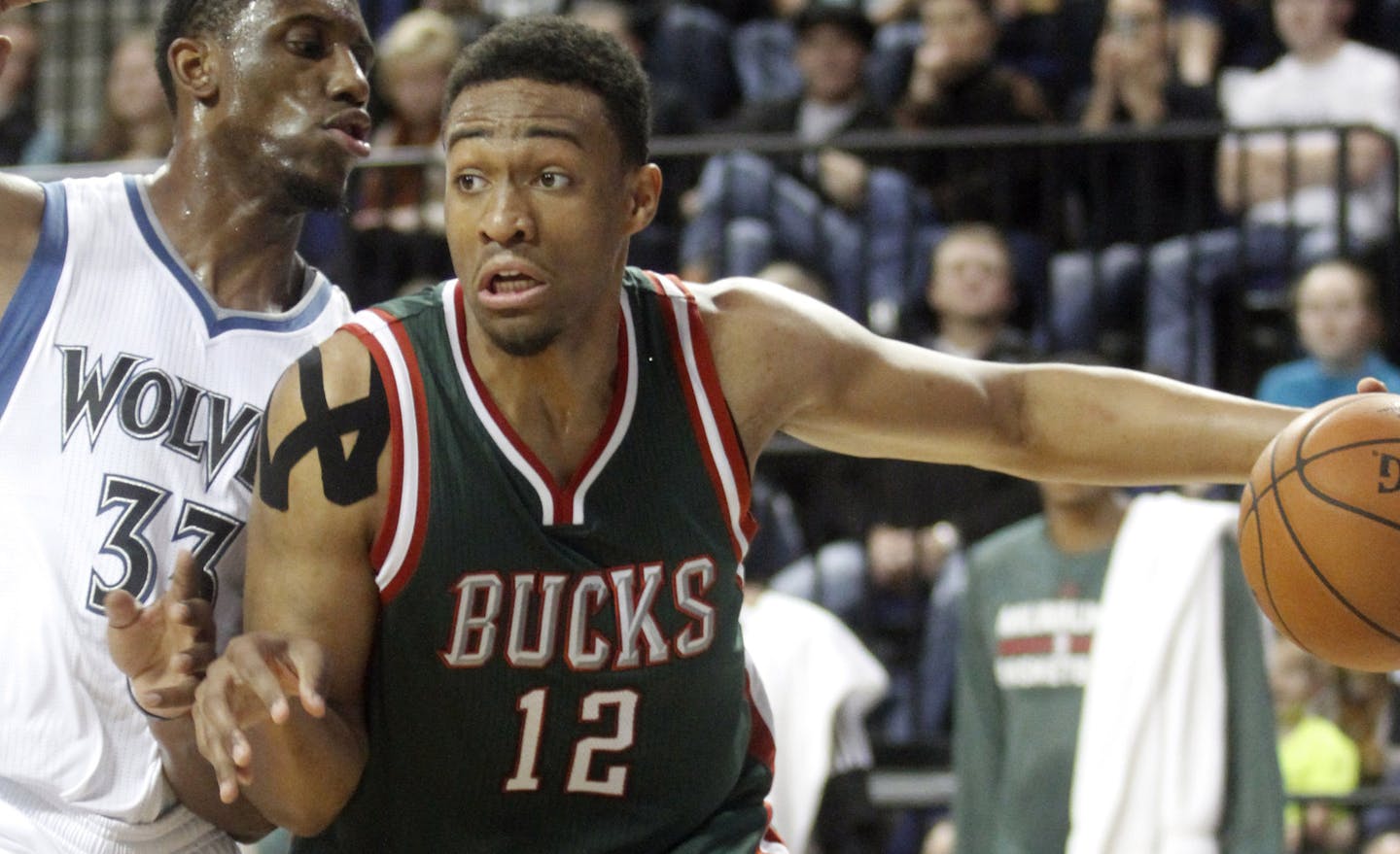 Milwaukee Bucks forward Jabari Parker, right, drives to the basket past Minnesota Timberwolves forward Andrew Wiggins during the first half of a preseason NBA basketball game, Friday, Oct. 17, 2014, in Cedar Rapids, Iowa. (AP Photo/Matthew Holst)