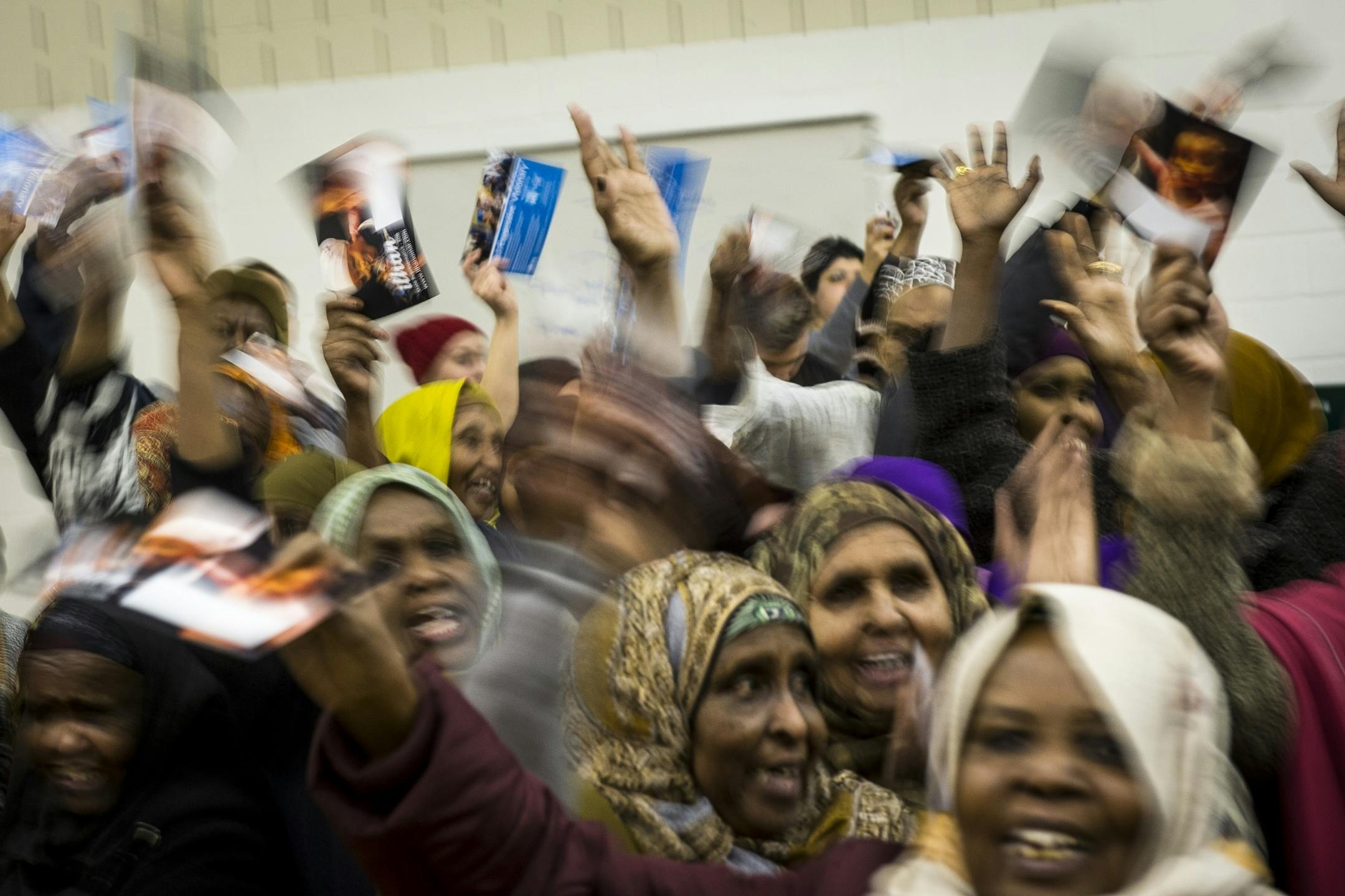 Supporters cheered before District 60B State Representative Candidate Ilhan Omar addressed the caucus Tuesday night at the Brian Coyle Center in Minneapolis.