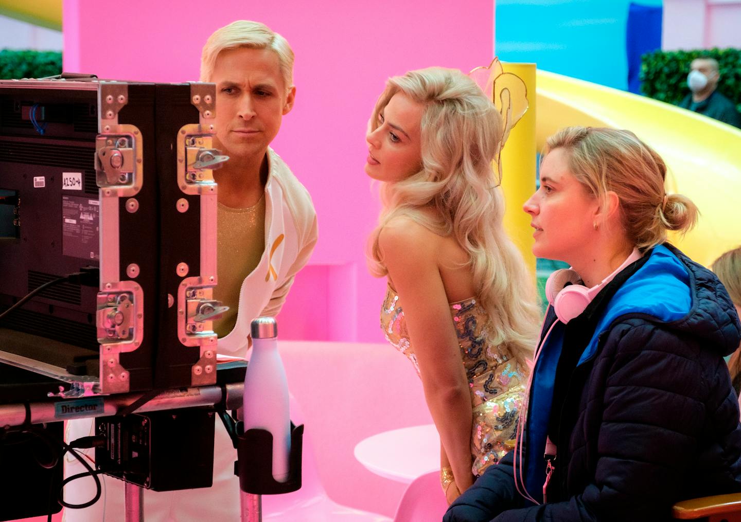 This image released by Warner Bros. Pictures shows actors Ryan Gosling, left, Margot Robbie, center, with director Greta Gerwig on the set of "Barbie.
