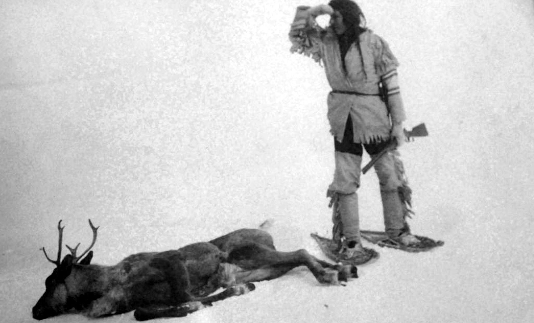 This Roland W. Reed photo from 1908 of an Ojibway Indian claimed to be of the last caribou shot in Minnesota.