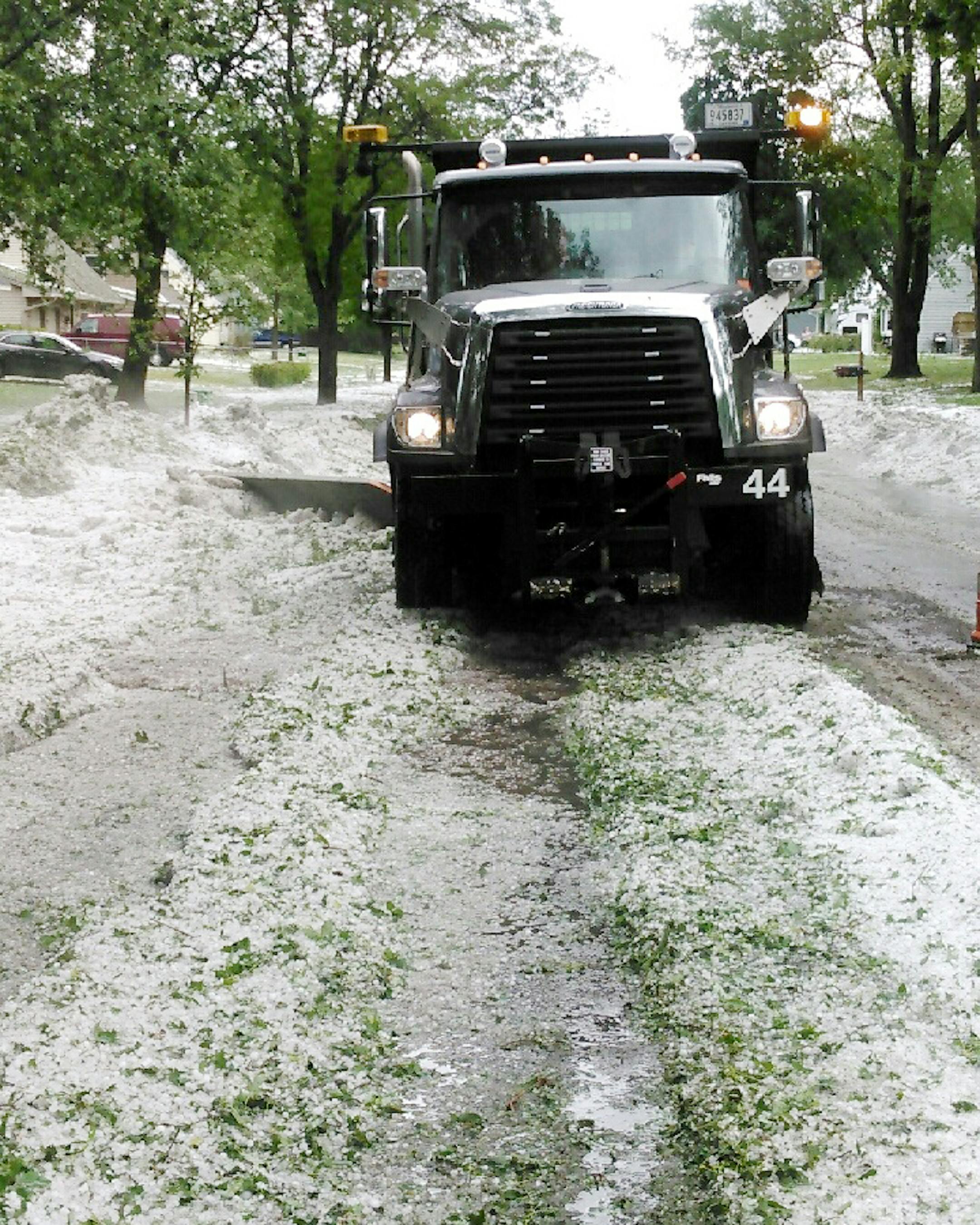 A Coon Rapids snow plow clears away hail from a June storm that battered the metro and left behind more than $600,000 in damage to Anoka County public property and infrastructure.