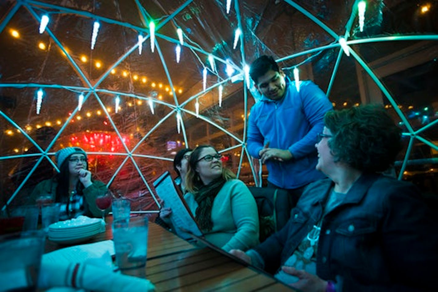 Server Peter Tazin took an order from Mayo colleagues, from the left, Hannah Wright, Jean Fox, Stacy Weelborg and Ruth Grimm in an igloo on the rooftop at La Vetta on Wednesday, January 10, 2018, in Rochester, Minn.