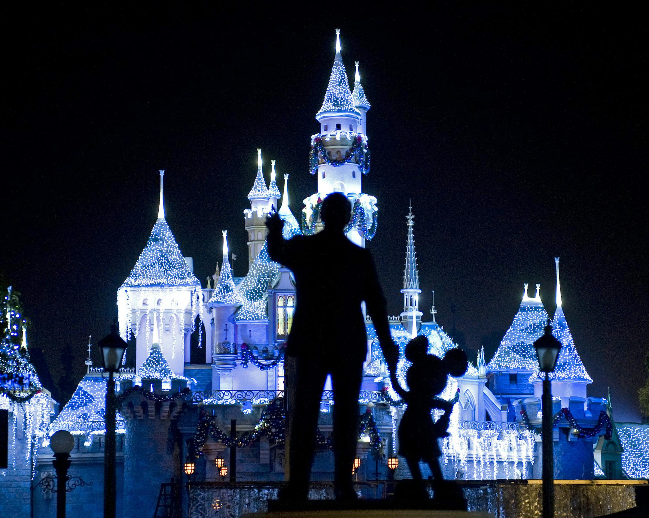 FILE - This Nov. 20, 2009 photo shows Sleeping Beauty's Castle in winter dress with the iconic "Partners" statue featuring images of Walt Disney and Mickey Mouse in the foreground, at Disneyland in Anaheim, Calif. Measles cases have been popping up around California in an outbreak linked to visits to Disneyland and Disney's California Adventure theme parks during the winter 2014 holiday. At least seventy people have been infected in a measles outbreak that led California public health officials