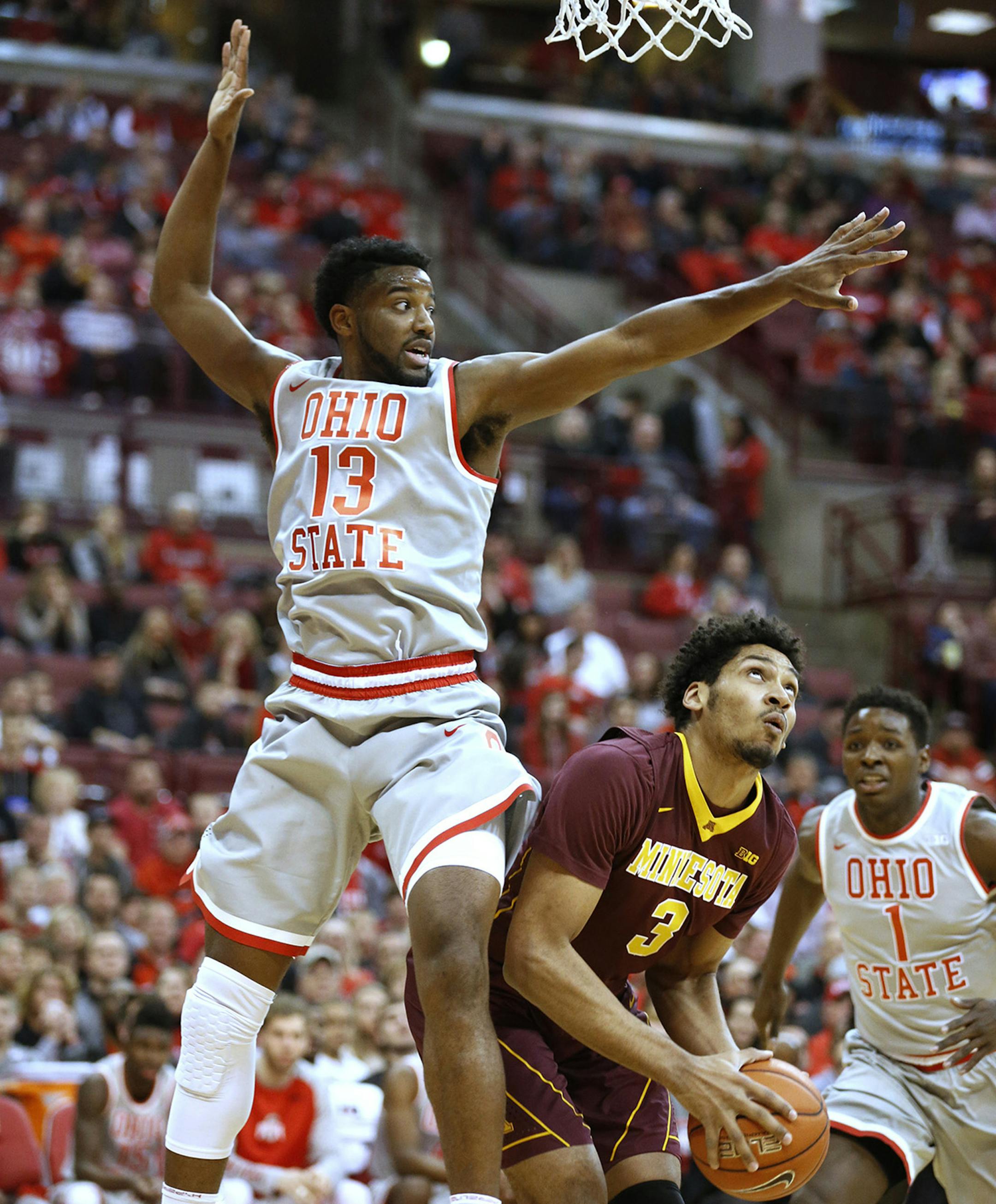 Ohio State's JaQuan Lyle (13) defends against Minnesota's Jordan Murphy (3) during the first half at Value City Arena in Columbus, Ohio, on Wednesday, Dec. 30, 2015. (Fred Squillante/Columbus Dispatch/TNS)