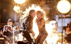 Lady Gaga, right, and James Hetfield of "Metallica" perform "Moth Into Flame" at the 59th annual Grammy Awards.