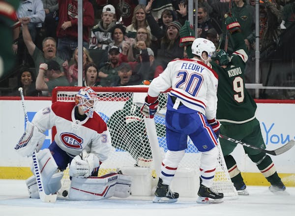 Minnesota Wild left wing Zach Parise (11), behind the net, scored the game winner in the third period, with an assist from center Mikko Koivu (9) and 