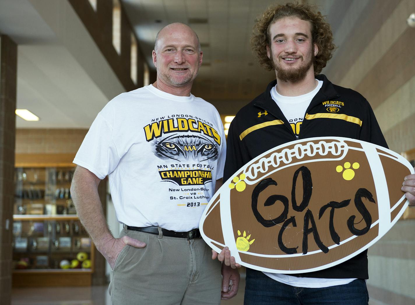 Ben Buening, a fullback on the New London-Spicer High School football team, and his father, Paul Buening, a physical education teacher at the school, stand near the school's gym on Thursday, Nov. 22, 2013. ] (Matthew Hintz, New London, 112213)