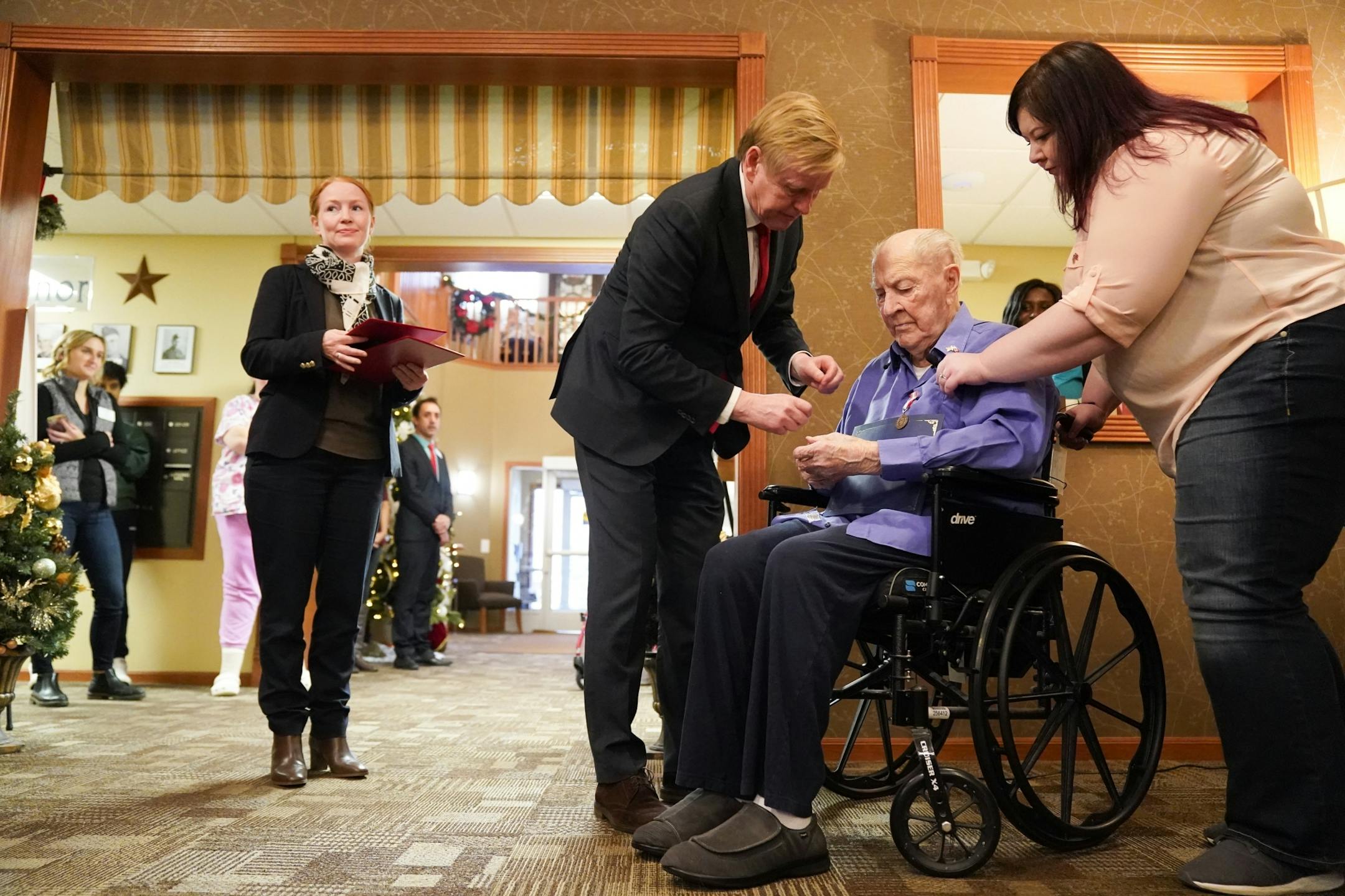 Norwegian Ambassador Kåre R. Aas presented two medals to 100-year-old Wilton Rasmusson, who served under the Office of Strategic Services' Norwegian Operational Unit, NORSO II, during World War II. On the right is Wilton's grand daughter Amber.