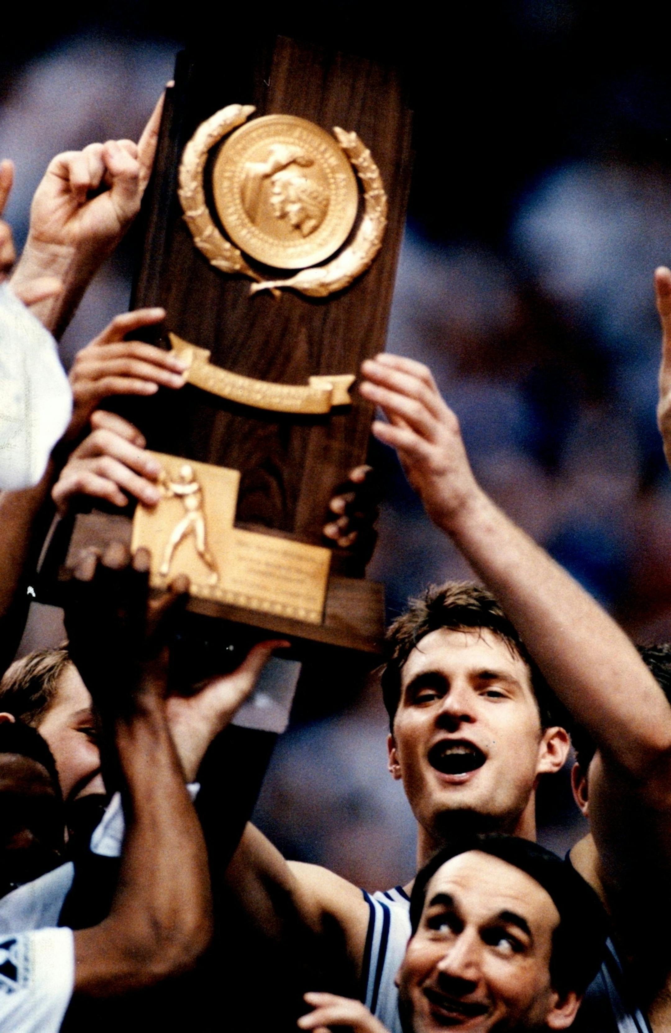 Duke coach Mike Krzyzewski and Christian Laettner celebrate with the NCAA championship trophy after defeating Michigan 71-51 in the 1992 Final Four. (Brian Peterson/Star Tribune)