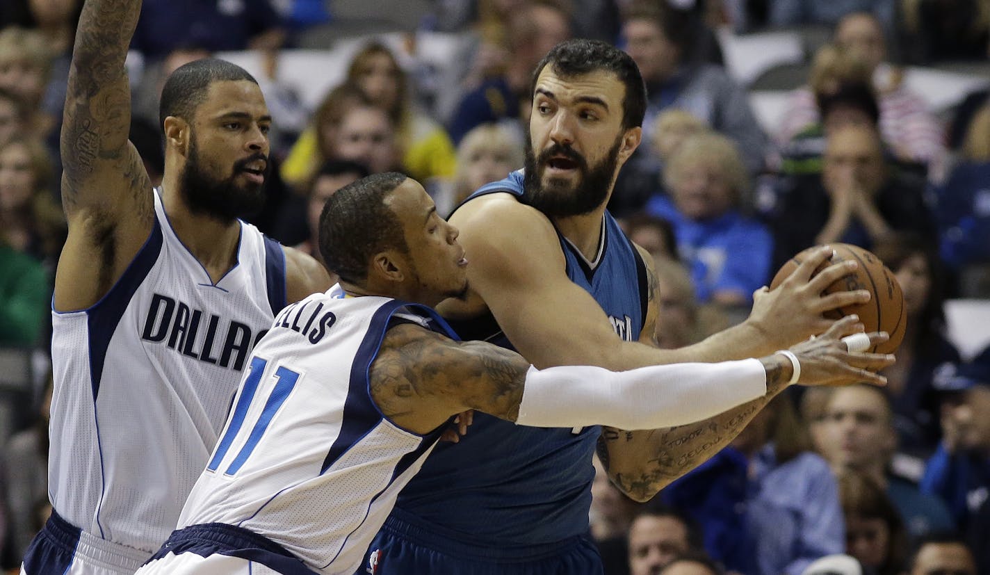 Minnesota Timberwolves center Nikola Pekovic (14) keeps the ball from Dallas Mavericks guard Monta Ellis (11) and center Tyson Chandler (6) during the first half of an NBA basketball game, Saturday, Nov. 15, 2014, in Dallas. (AP Photo/LM Otero)