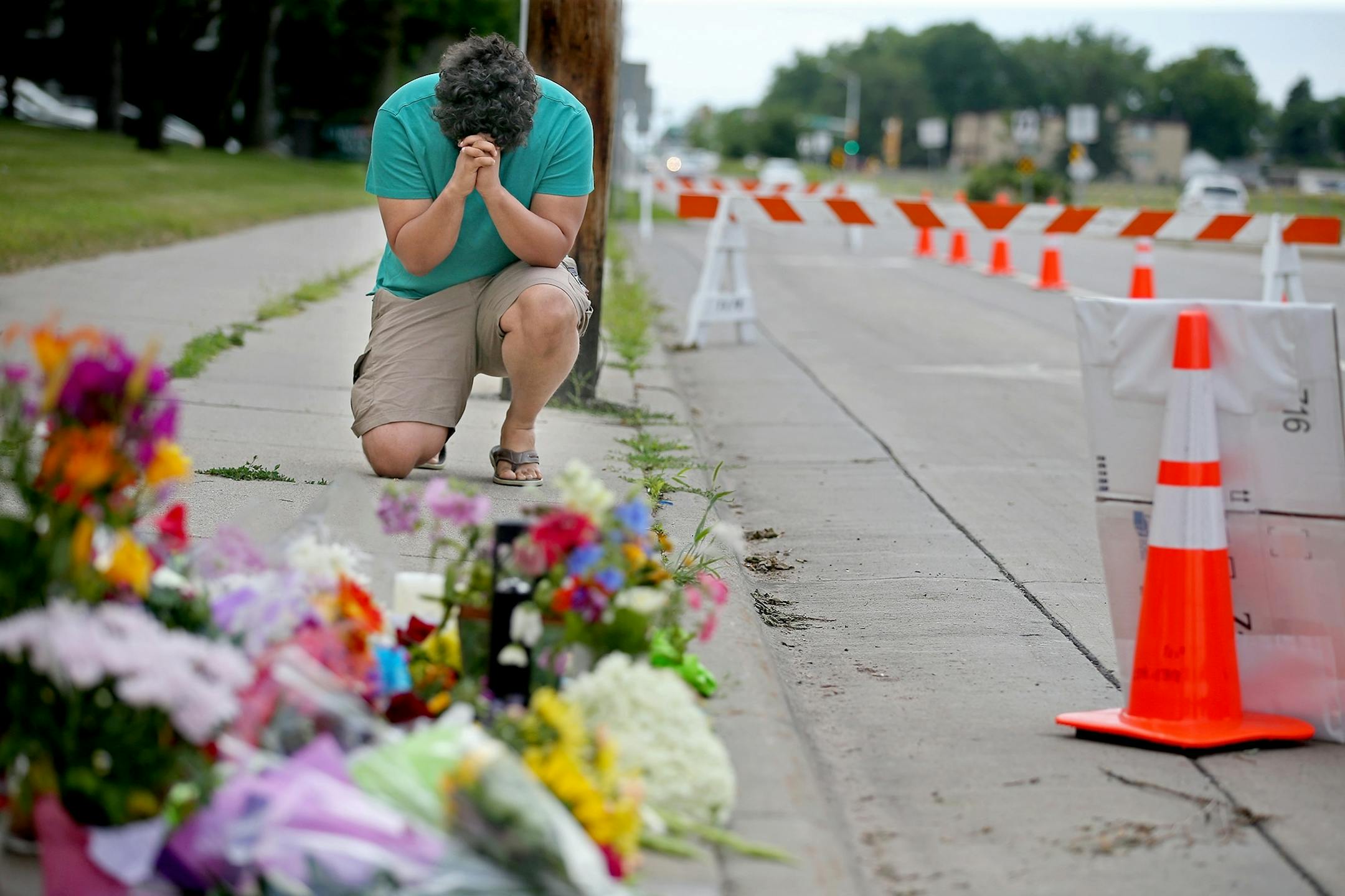 "It could have been me," said Drew Meeks III, of Falcon Heights as he prayed near the scene where Philando Castile was shot by a police officer, Thursday, July 7, 2016 in Falcon Heights, MN. Toso lives a less than a block away.
